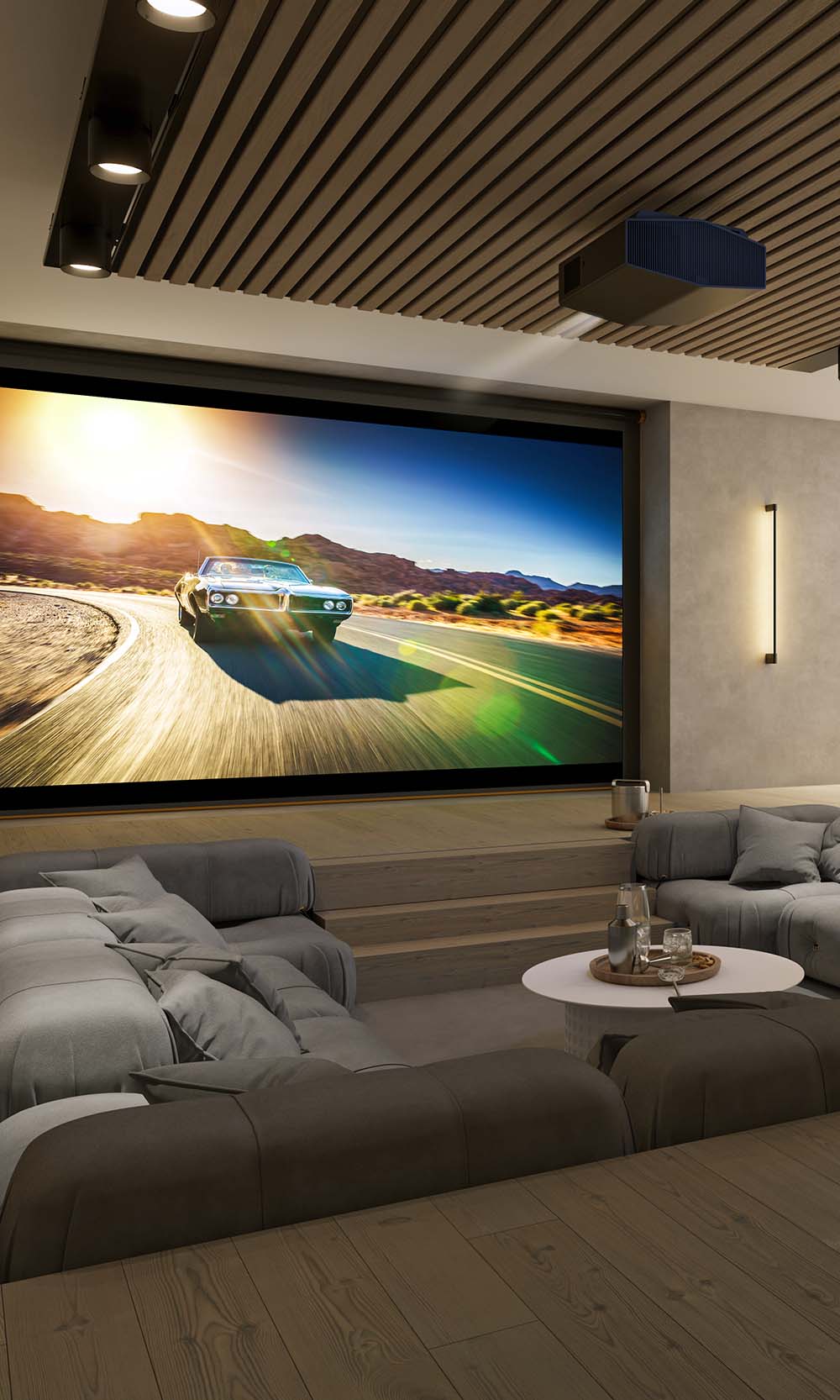 Large home theater projection screen displaying a car on a road in front of modern seating