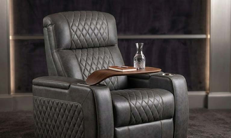 black reclining couches with wooden tray tables