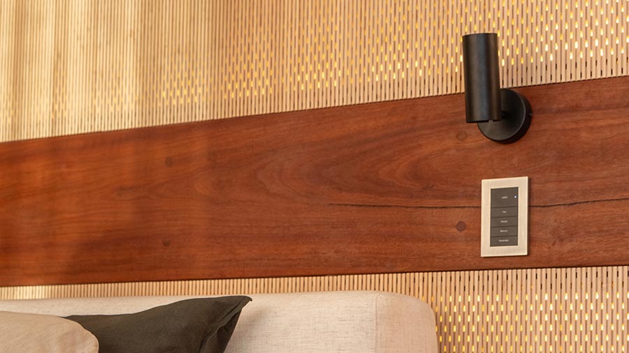 Black light fixture and control panel mounted on a wood and textured wall