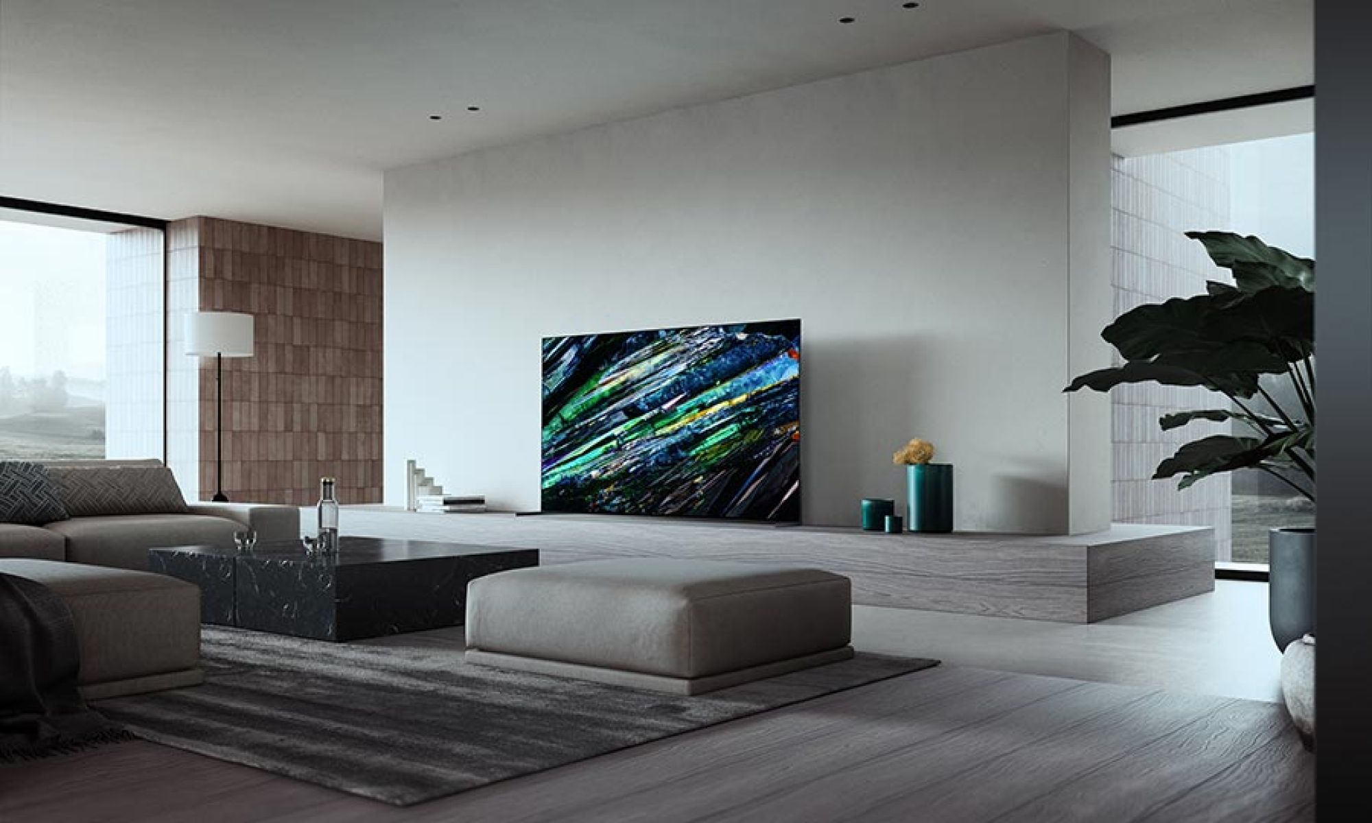 Sleek television displaying vibrant colors on a low shelf in a minimalist living room