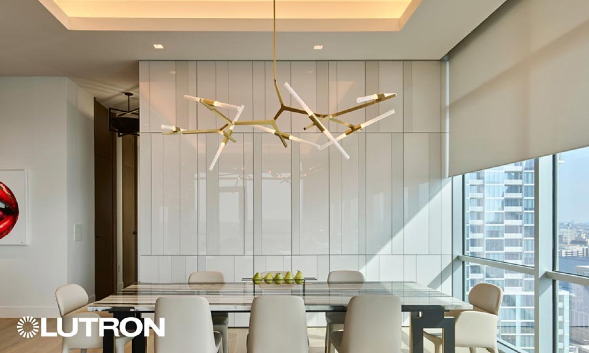 Modern geometric chandelier above a dining table with motorized window shades